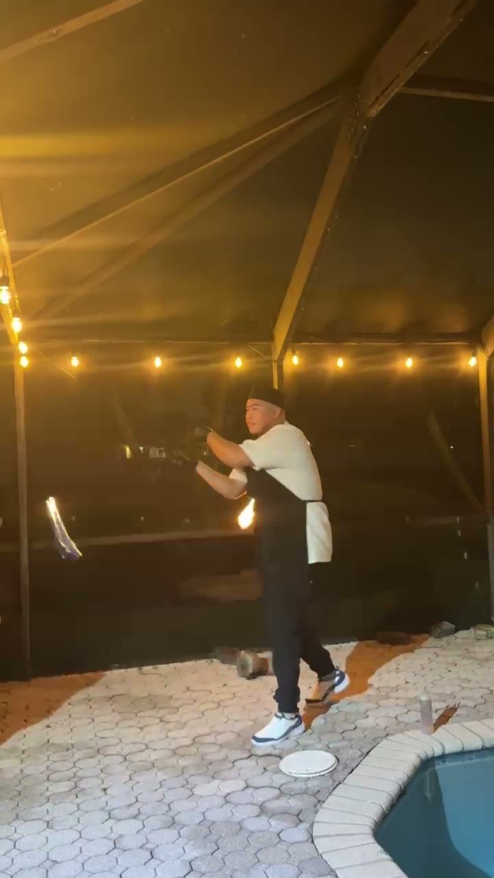 Fire poi spinning by the pool at night