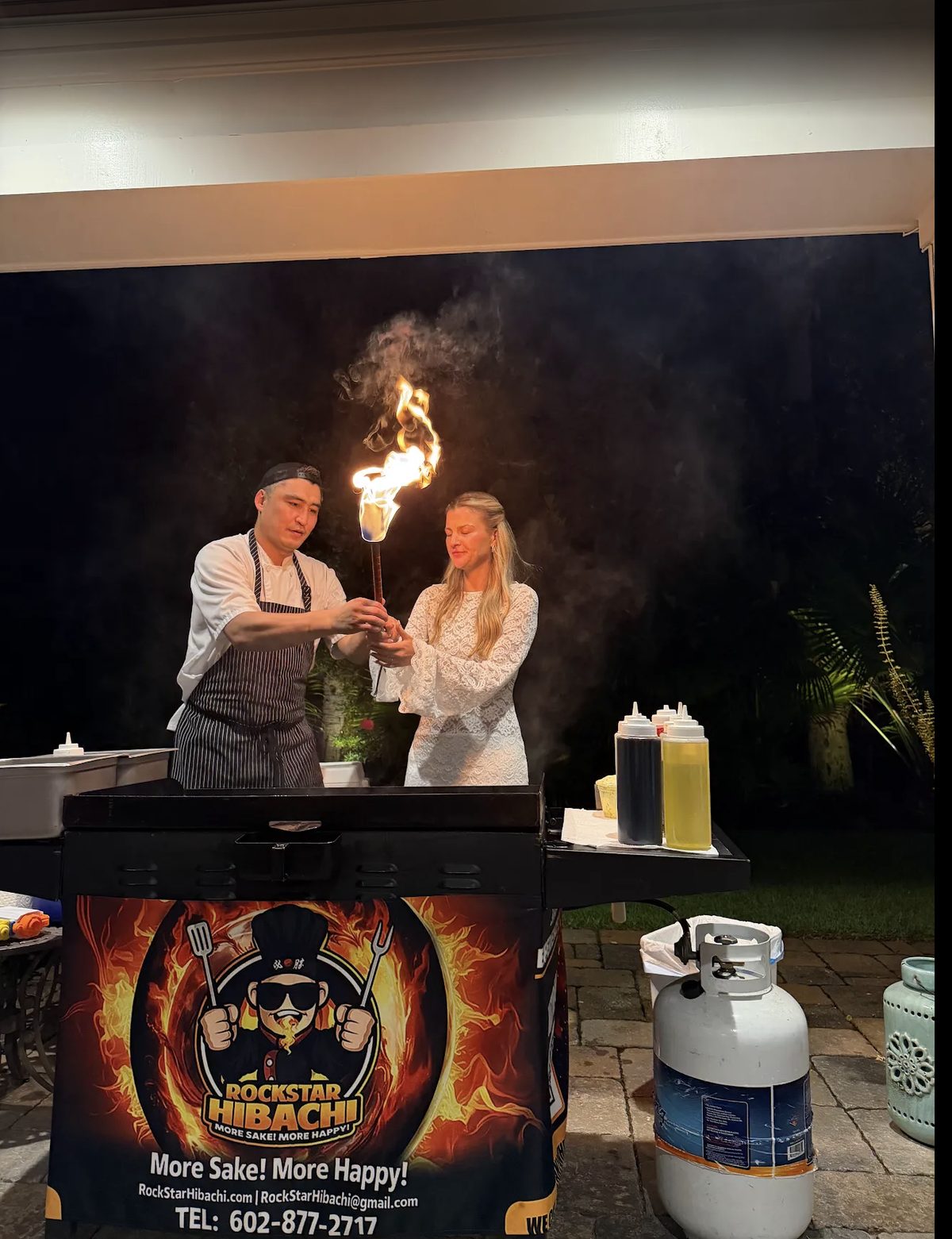 Chef performing a fire torch trick for a bachelorette party guest